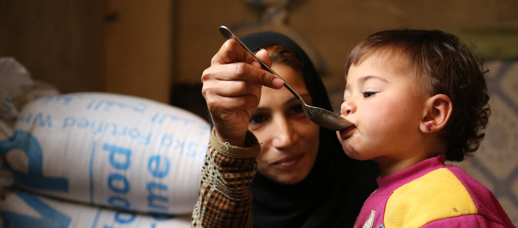 madre siria alimenta a su bebé