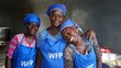 From left to right, volunteer cooks Magali, Simone and Josie prepare meals in the school kitchen in Gonaïves, Haiti. Nationwide, 420,000 students receive daily meals with WFP’s support. Photo: WFP/Pedro Rodrigues