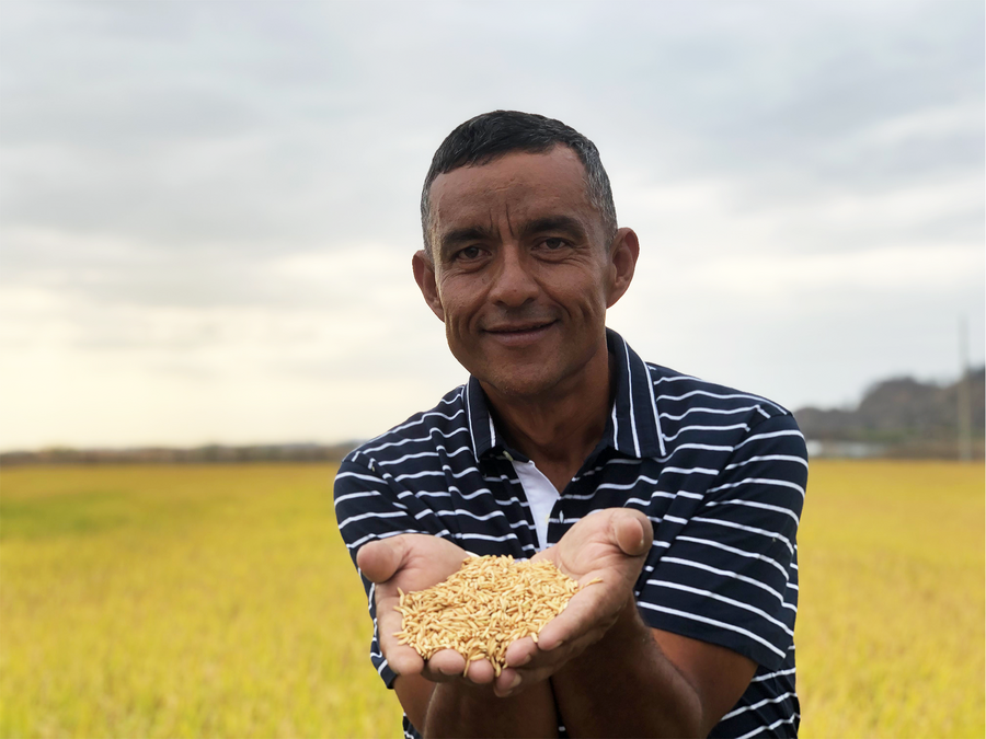Patricio Valencia sostiene granos cultivados en su finca.