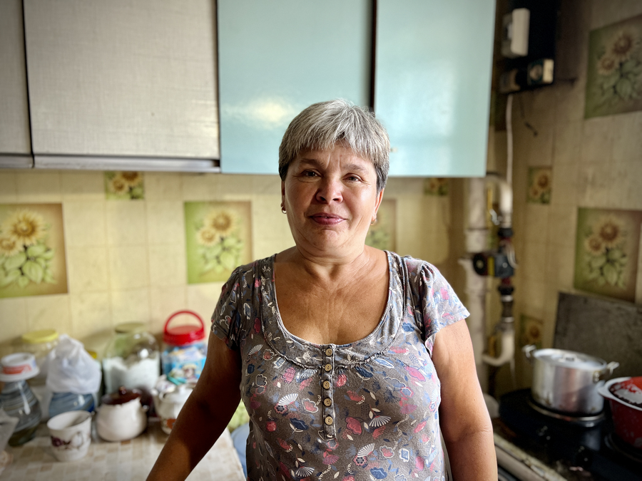 A woman beneficiary of WFP food kits stands in her kitchen in Sloviansk, Ukraine