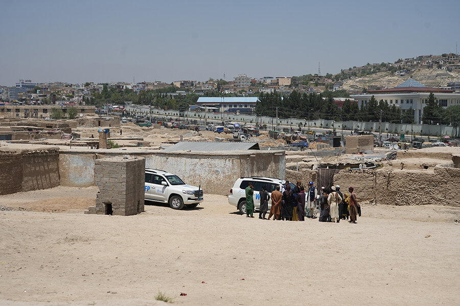 WFP SUVs arrive at settlement in Kabul City where WFP has cut rations
