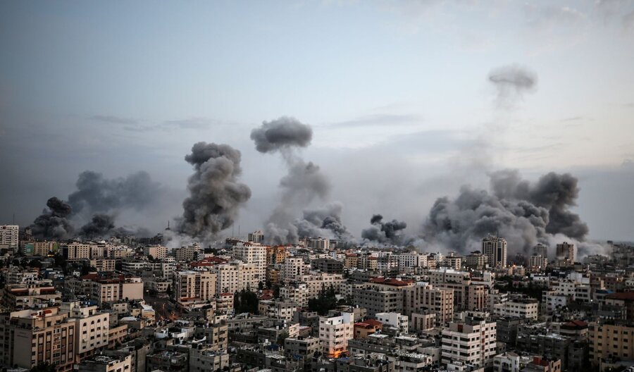 plumes of smoke over bombarded city