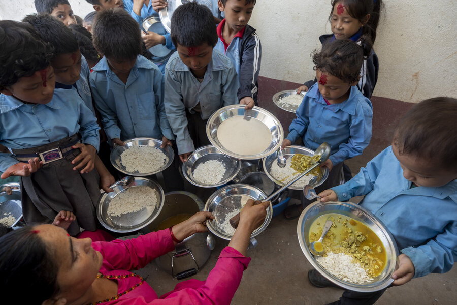 Niños recibiendo comidas escolares en Nuwakot. Foto: WFP/Monica Upadhyay