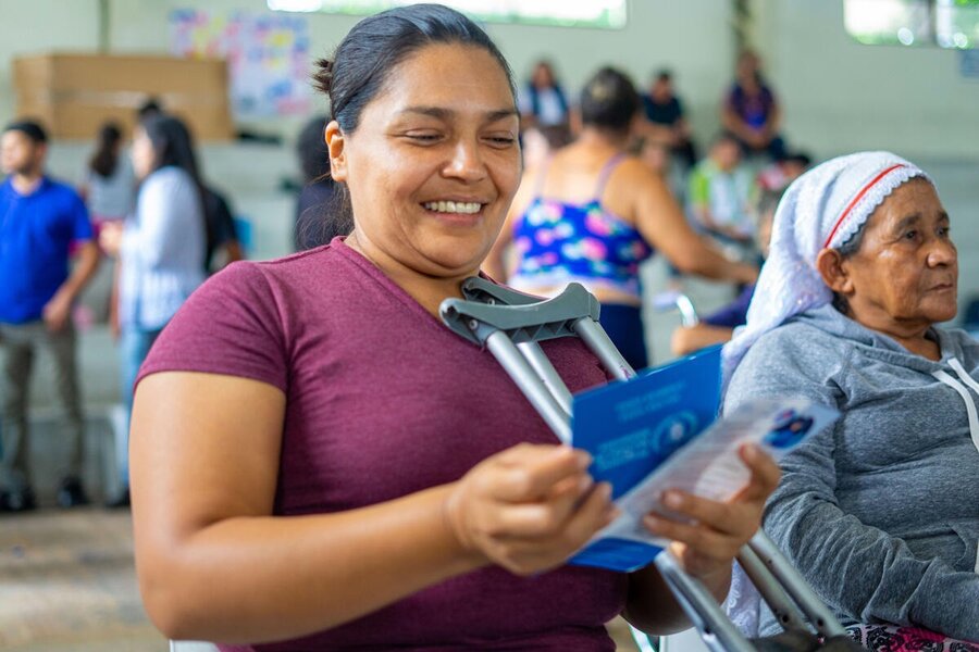 Women receives cash assistance in El Salvador