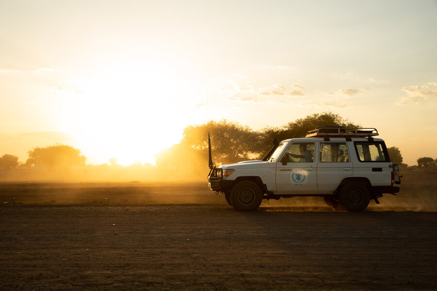 Side view of WFP truck travelling along track in reduced sunlight