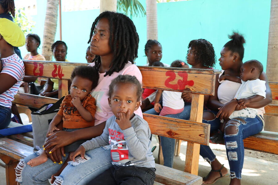 The infant, nine-month-old Mohamed Belrive (L), with his family at a WFP-supported nutrition clinic in northern Haiti. Photo: WFP/Alexis Masciarelli