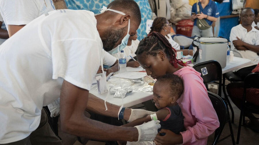 A health worker tests a displaced child for malnutrition in Haiti's capital, Port-au-Prince. Photo: WFP/Maria Gellar