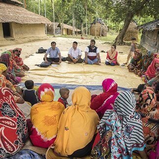 Group of people listening to WFP staff. Photo: WFP/Saikat Mojumder